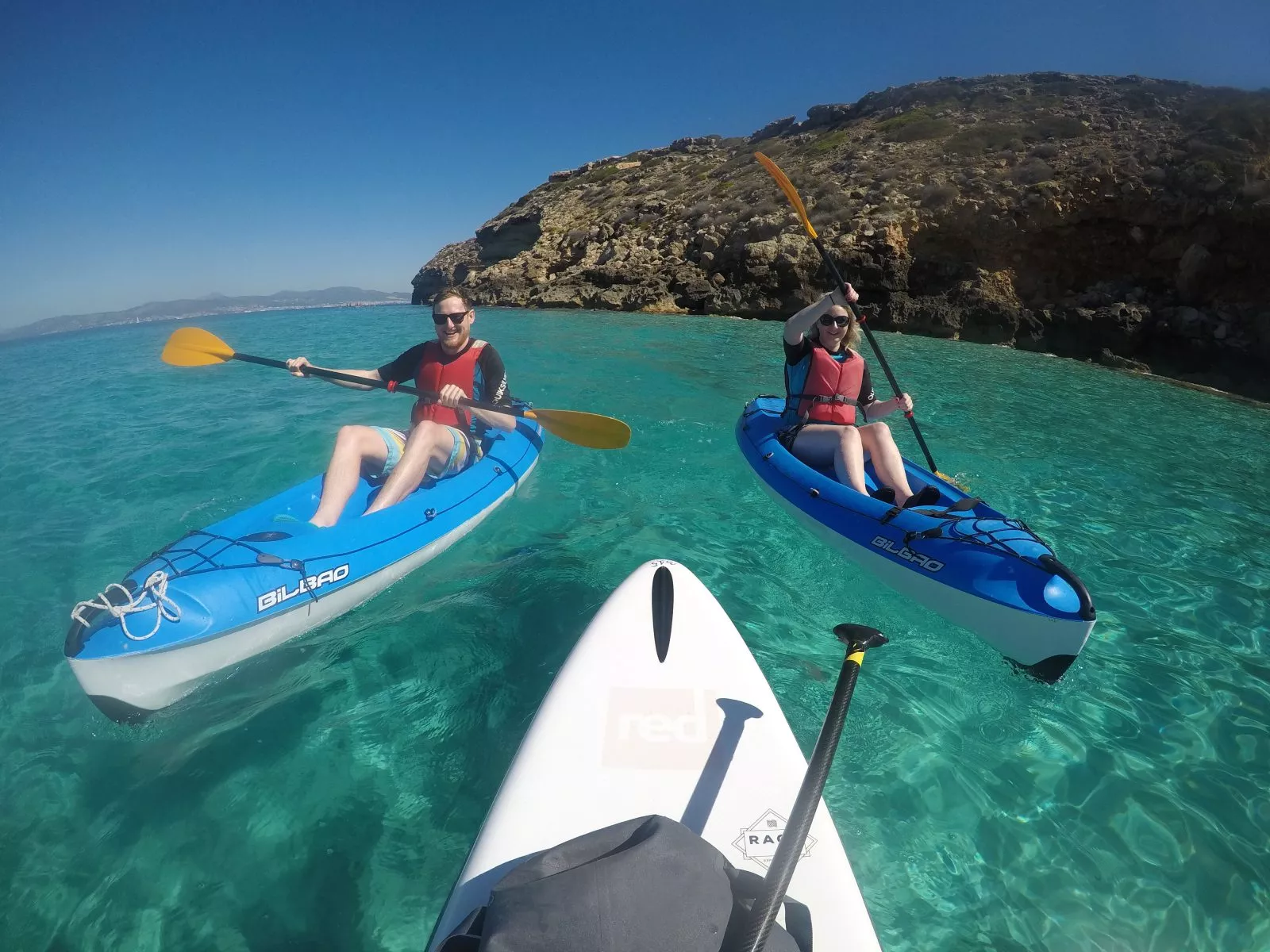 Group kayak tour on turquoise waters with BonaOna Surf School Mallorca