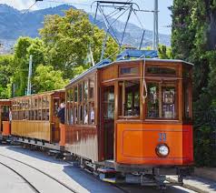 Wikimedia view of Sóller train station with vintage train and mountains
